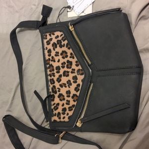 VR black with Leppard details. Zipper details, adjustable straps. NWT